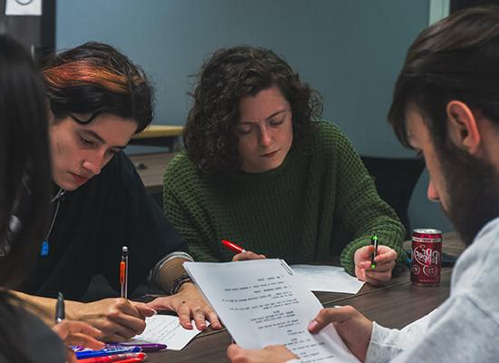 在线博彩 film and production students working on a script